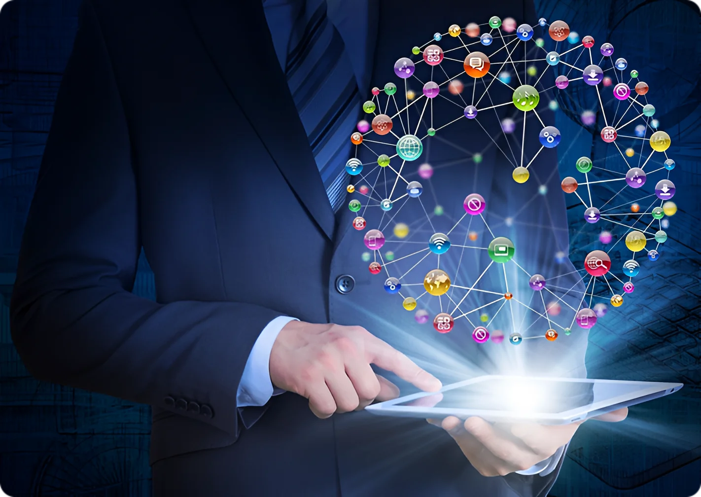 A man in a suit holding an ipad with a bunch of colorful images coming out it.