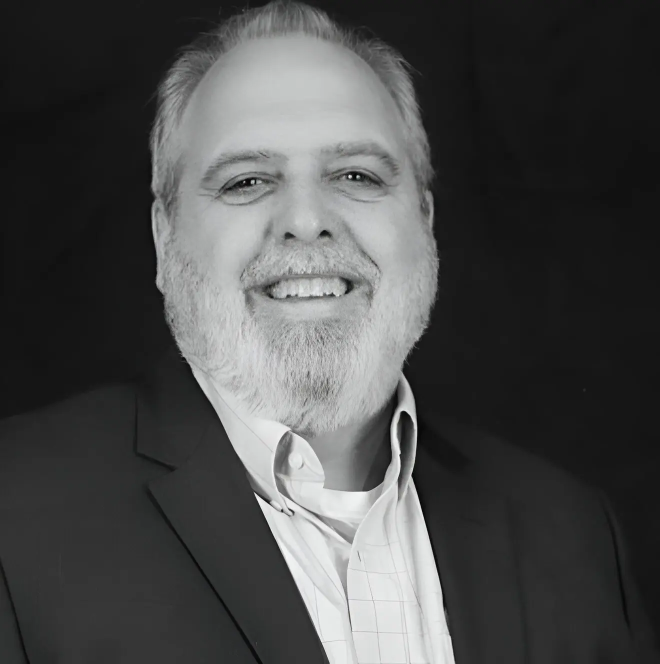 A man with a beard and suit jacket